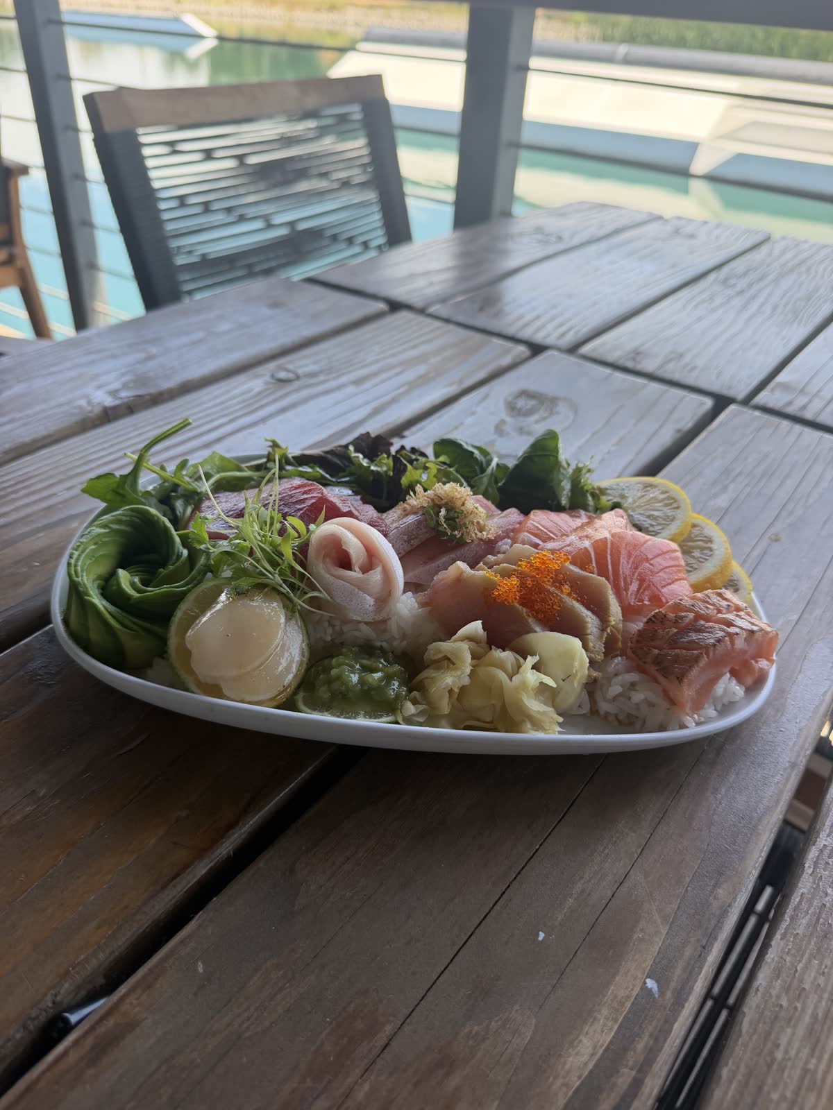 Chirashi platter on a weathered deck table