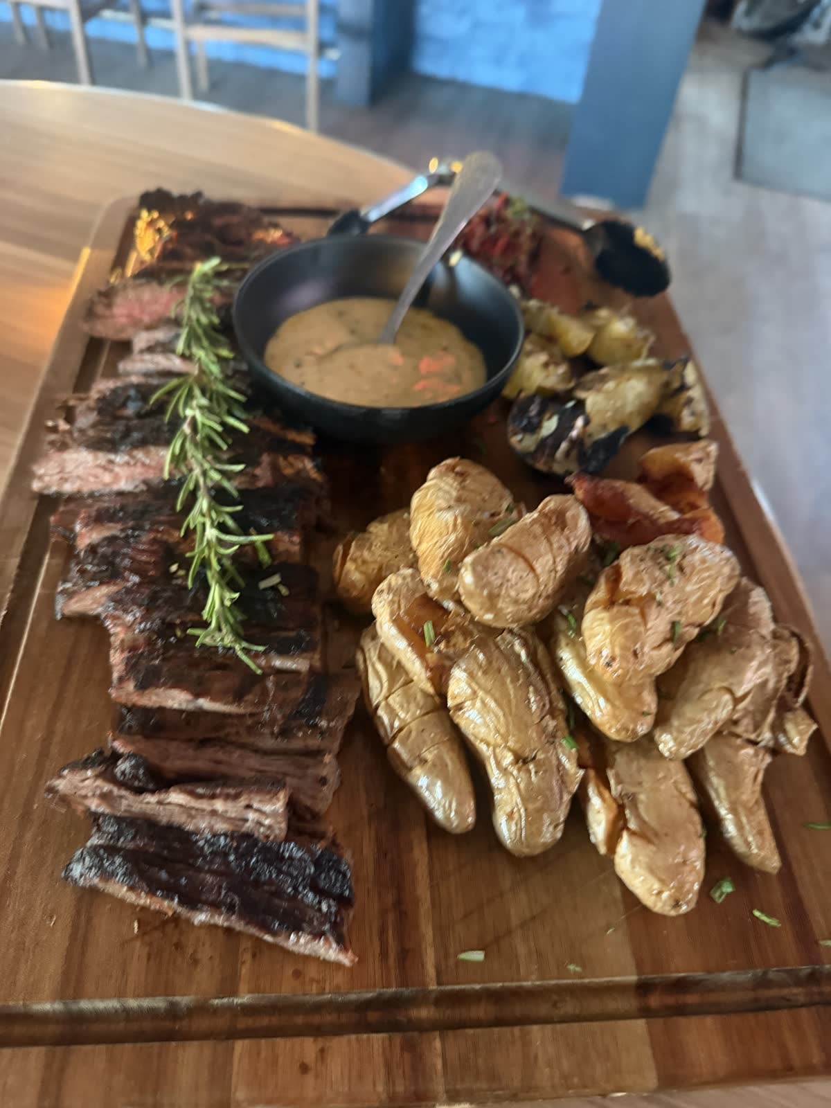 Wood-fired steak board with fingerling potatoes